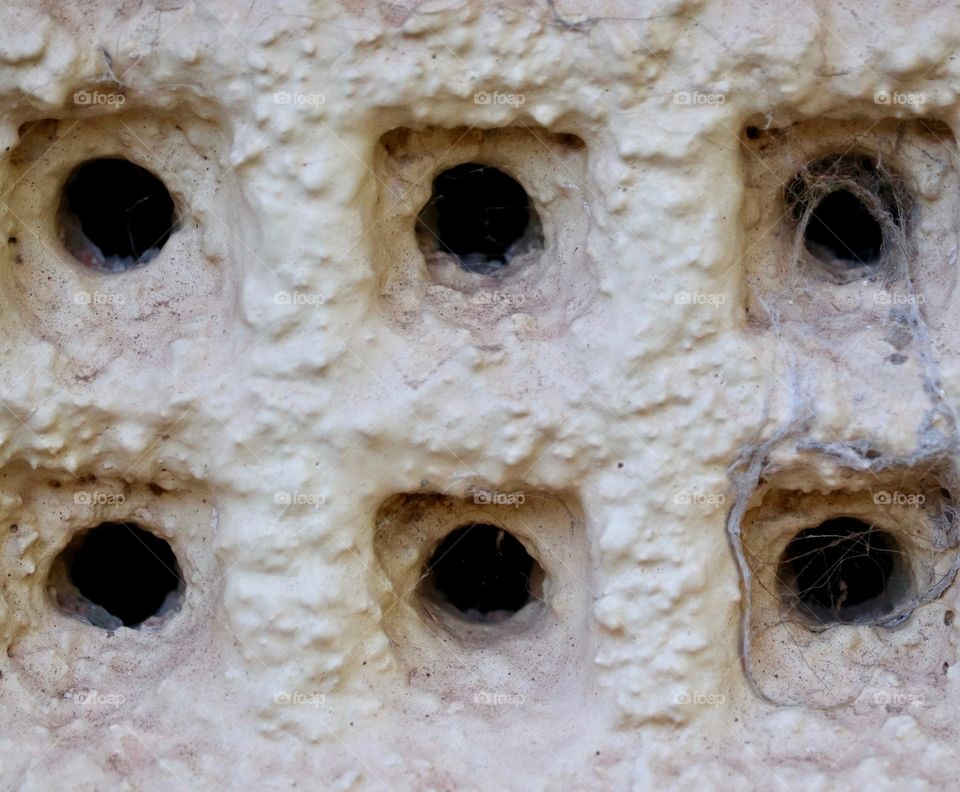 Old air vent on exterior stucco wall of old home textural image