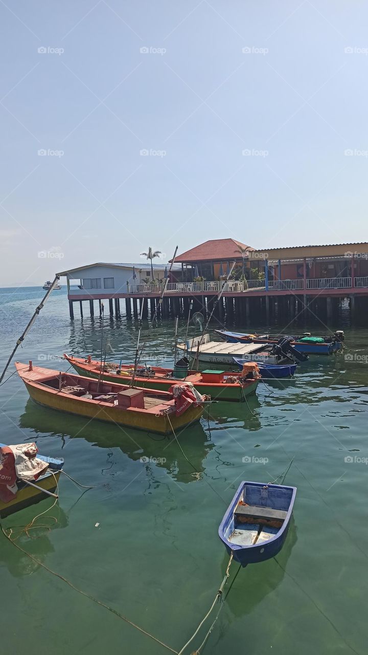 red boats next to the houses in tailand