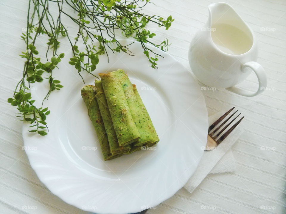 Green pancakes. Green pancakes on white plate