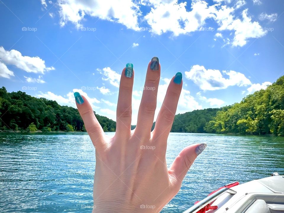 Admiring my summer blue gel nails while out on the boat 