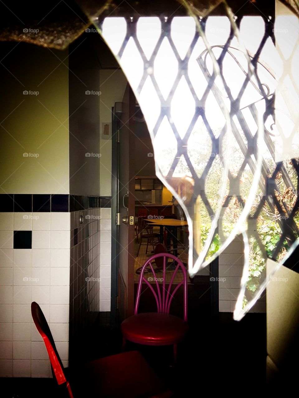 Abandoned restaurant seen through broken winfow