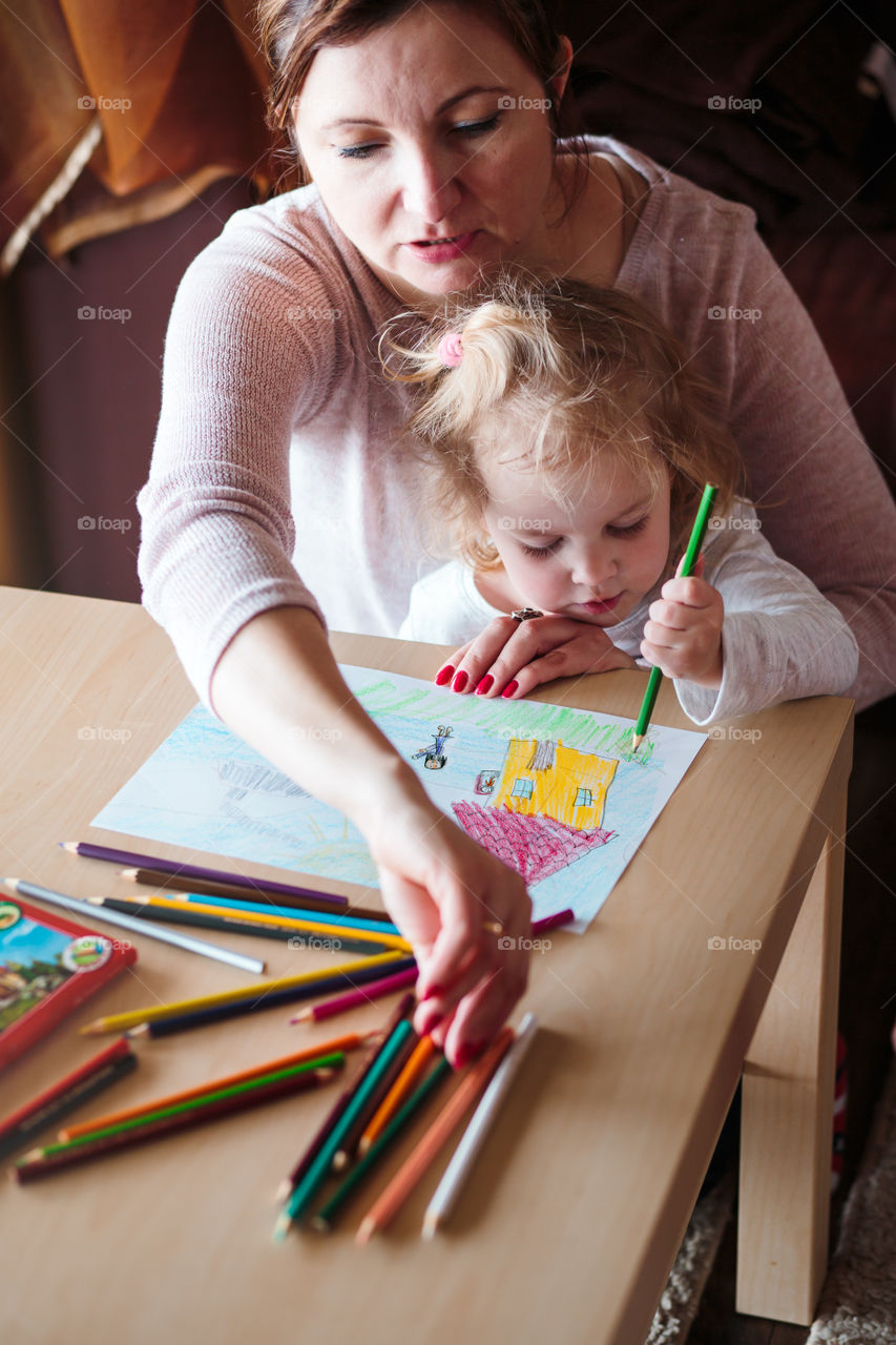Colours of the world. Children with mom drawing using crayons