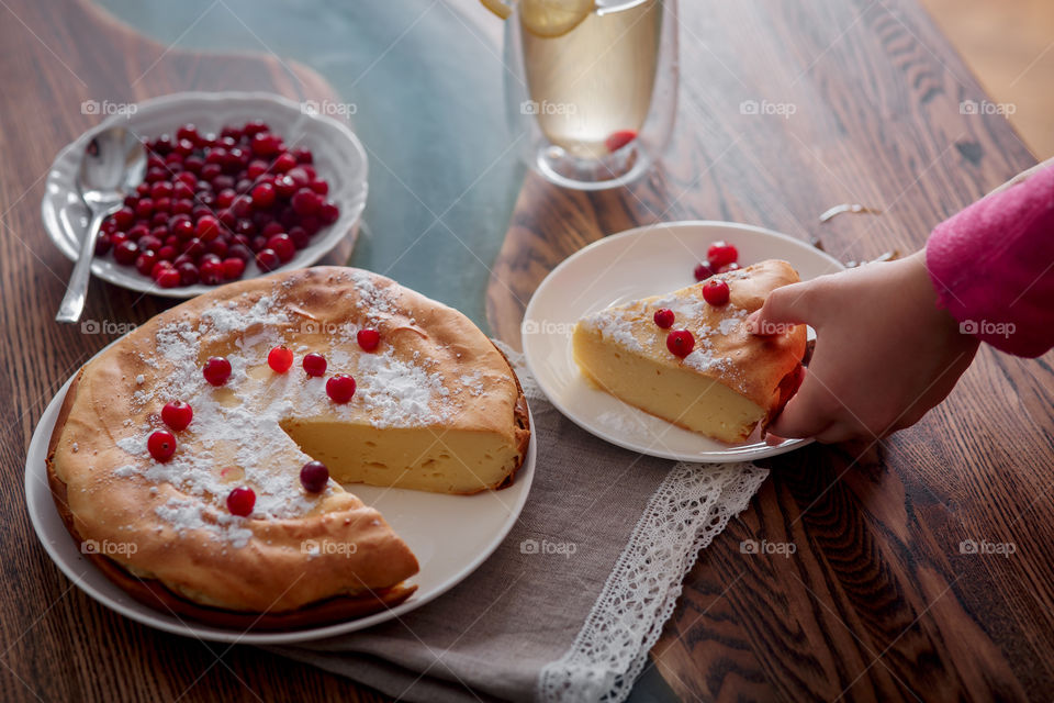 Children breakfast with cheesecake. Hands, detail