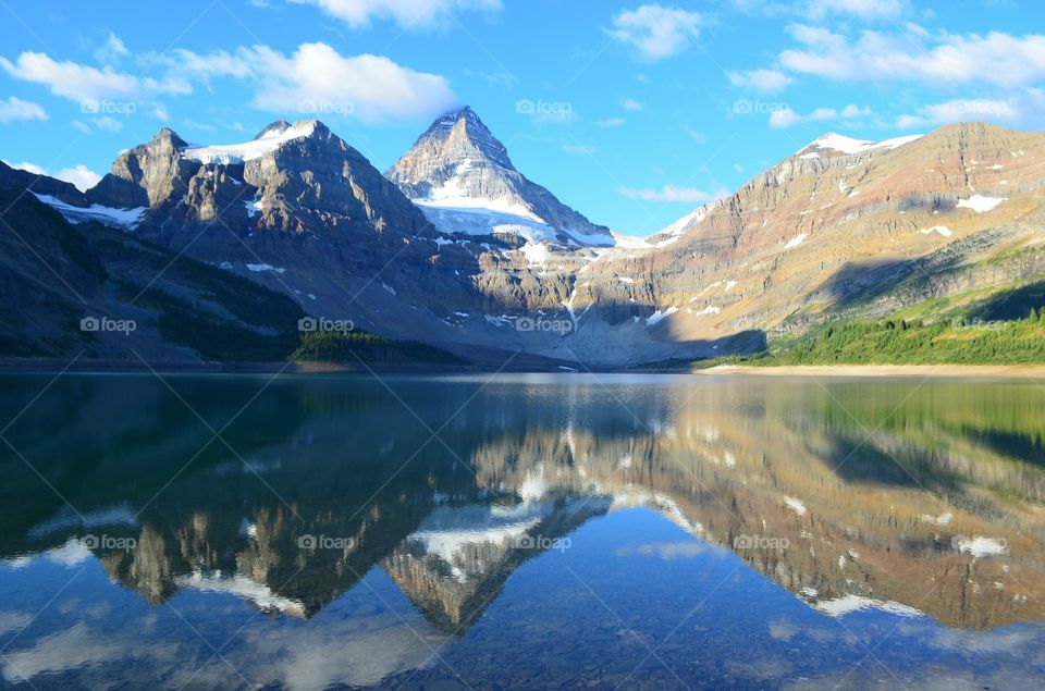 Snowy mountain reflecting in lake
