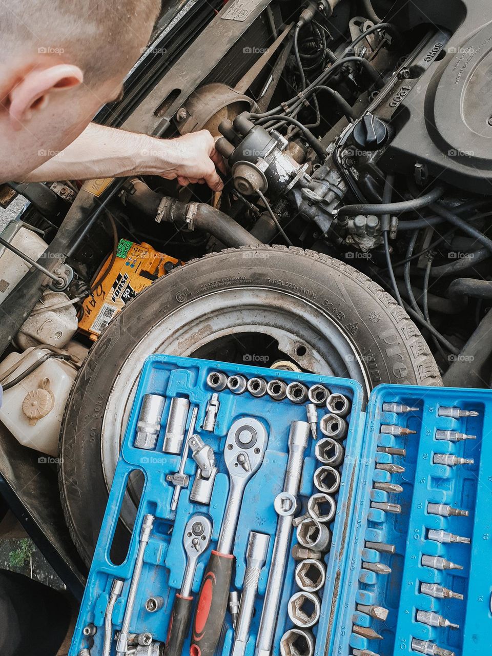 Photo of car repair and box with mechanic's tools