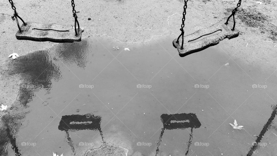 Reflection of children's swing in a puddle