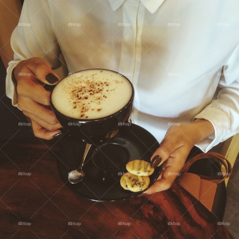 Woman holding coffee cup 