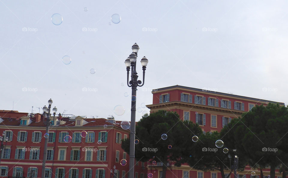 Bubbles in foreground of view of Place Massena in Nice, France.