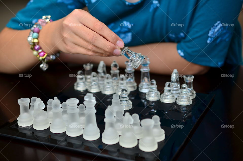 A hand playing chess