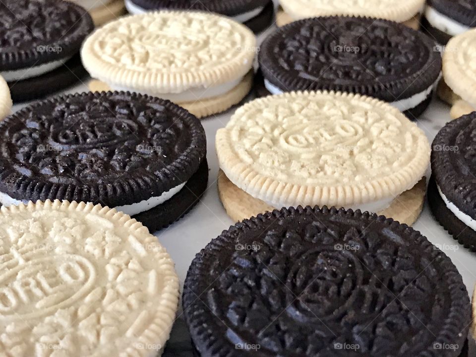 Golden and chocolate double stuff Oreo cookies Contrasting flat lay