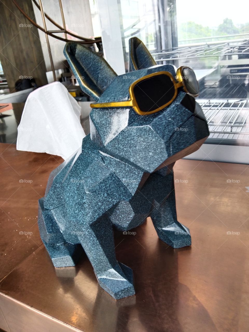 dog sculpture holds tissues