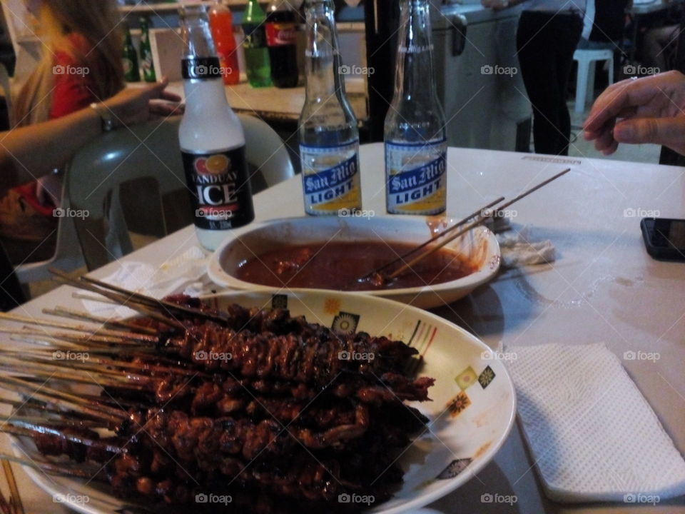 having a drink of beer with barbecue after a hectic day during a vacatin. this is perfect.