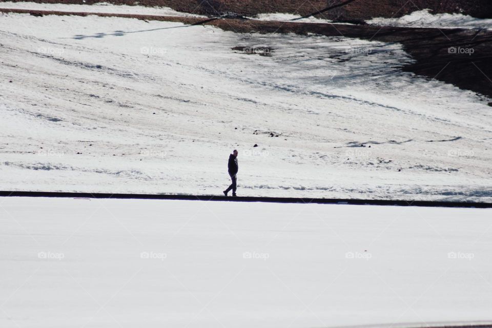 Man walking by lake