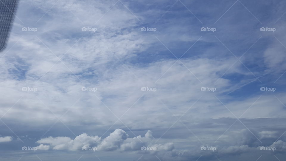 The blue sky shines through on a cloudy day.