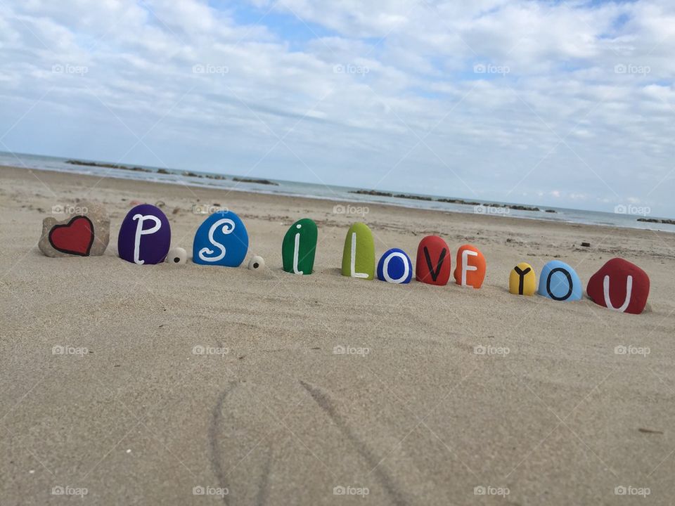 P.S. I love you on stones, beach background