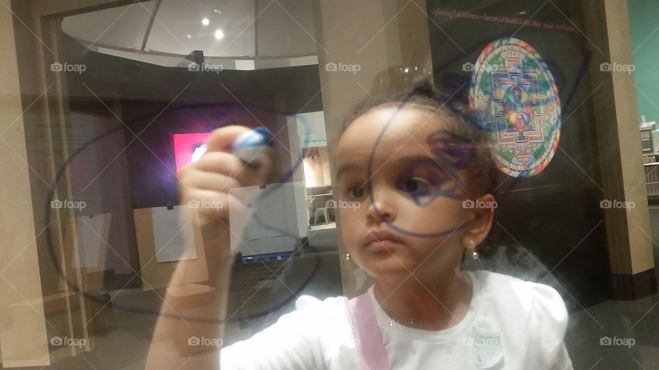 Close-up of little girl holding pen marker