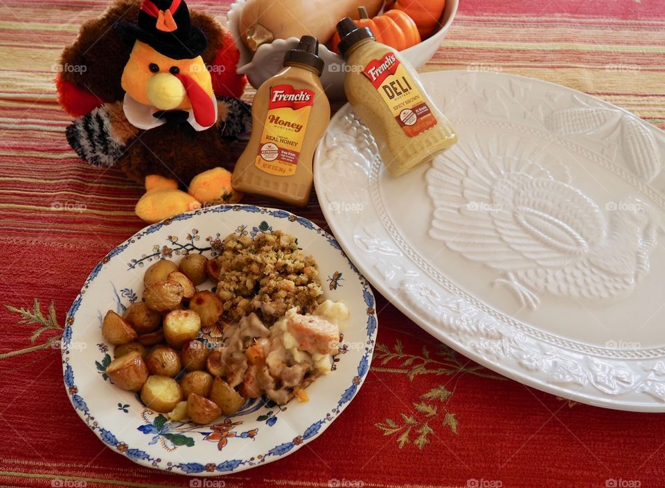 Thanksgiving plate of turkey in a creamy French’s deli and honey mustard sauce with stuffing and roasted potatoes.