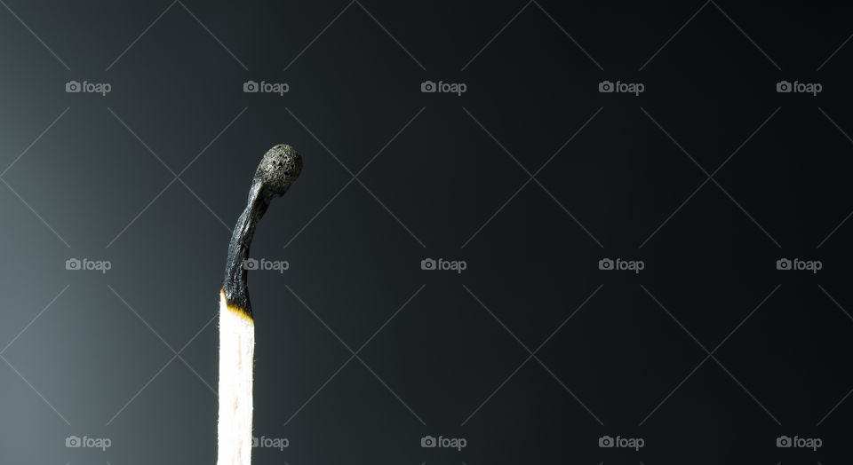 burnt match on a black background. dying life concept