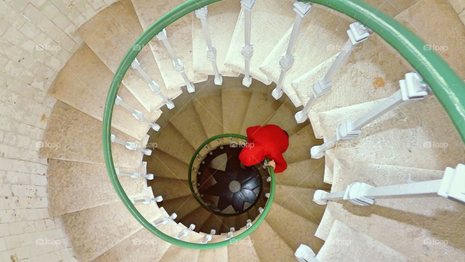 Boy looking down at the spiral staircase