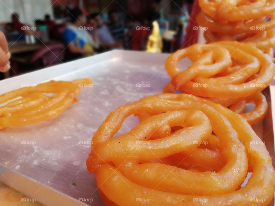 Indian tradional sweet jalebi or jelebi, Jalebi, also known as zulbia and zalabia, is an Indian sweet and popular food found all over South Asia and the Middle East. It is made by deep-frying maida flour batter in pretzel or circular shapes.