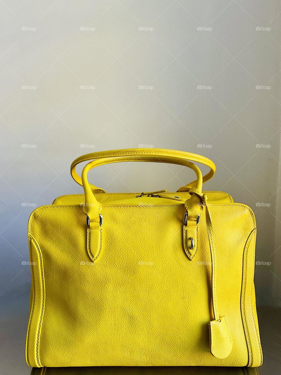 A yellow tote bag -ideal for carrying essential items during the summer. 