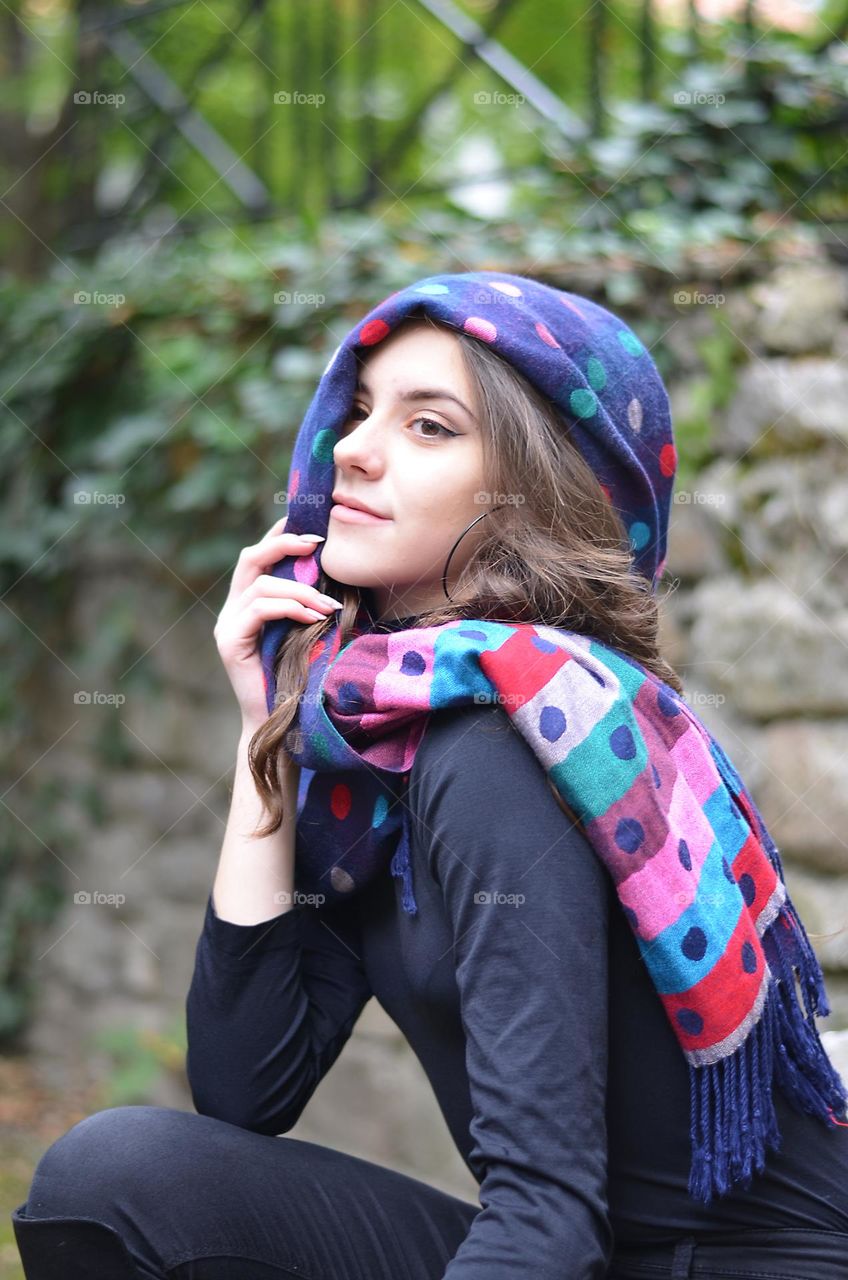 Portrait of a woman brunette with polka dot scarf