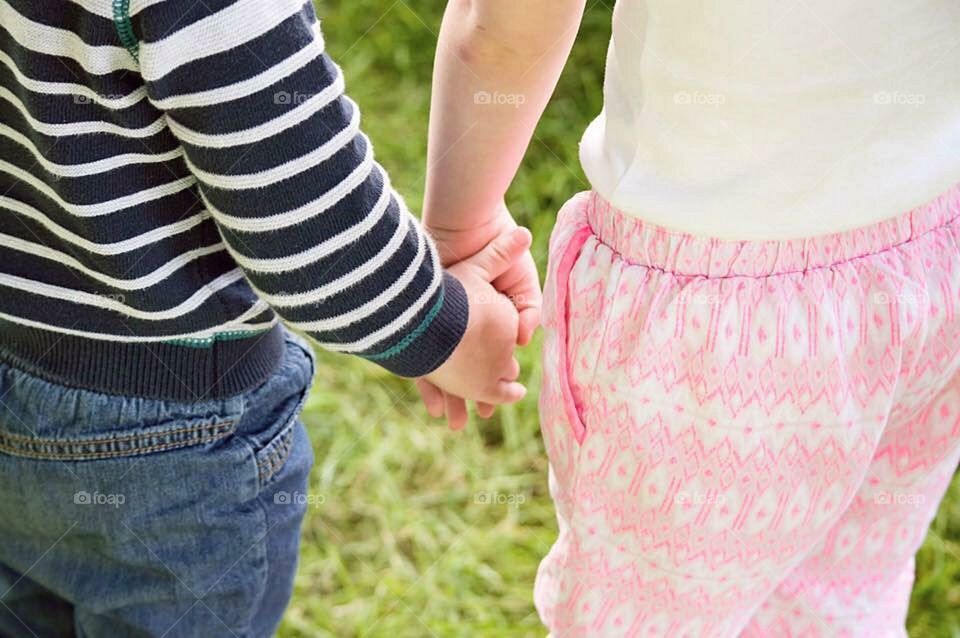 Siblings holding hands