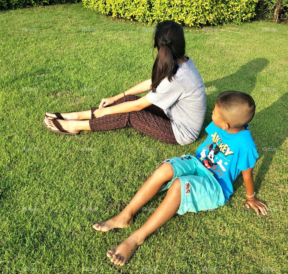 Childrens are relax on the lawn.