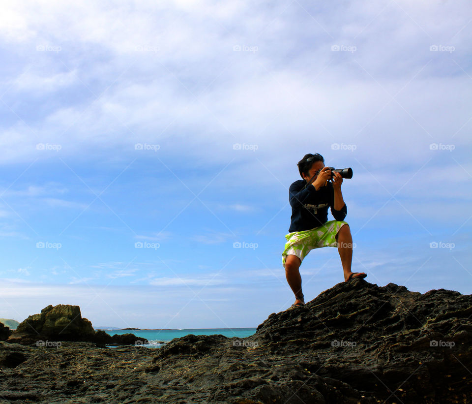 photographer atop a rock