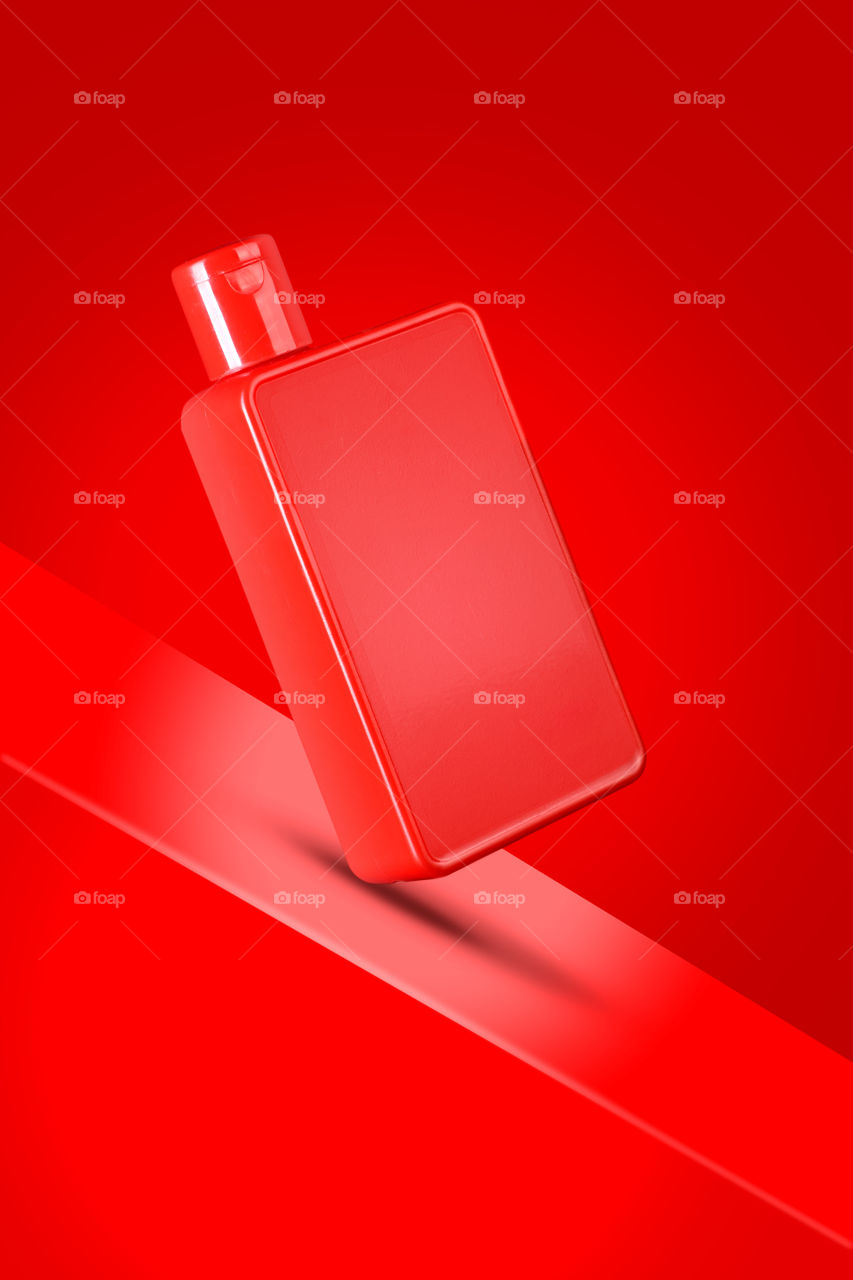 Red colored sanitizer / shampoo or shower gel bottle