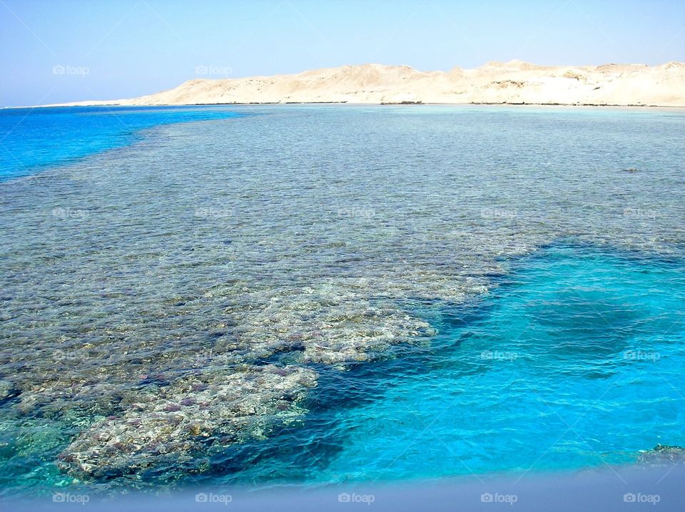 Coral reefs with rocks on horizon 