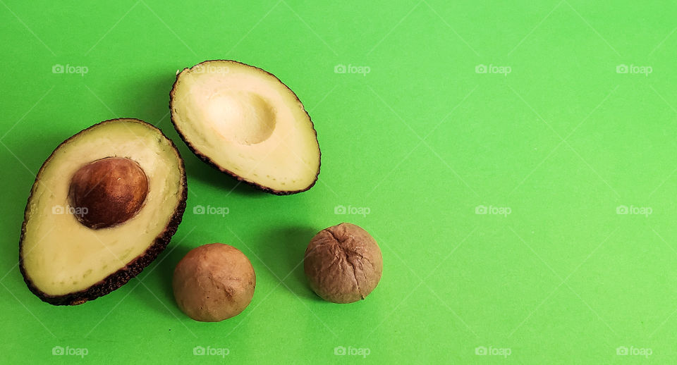 cut avocado on green background.