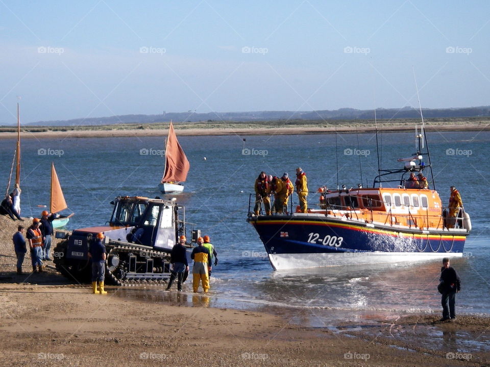 RNLI Lifeboat being pulled up the beach in Norfolk