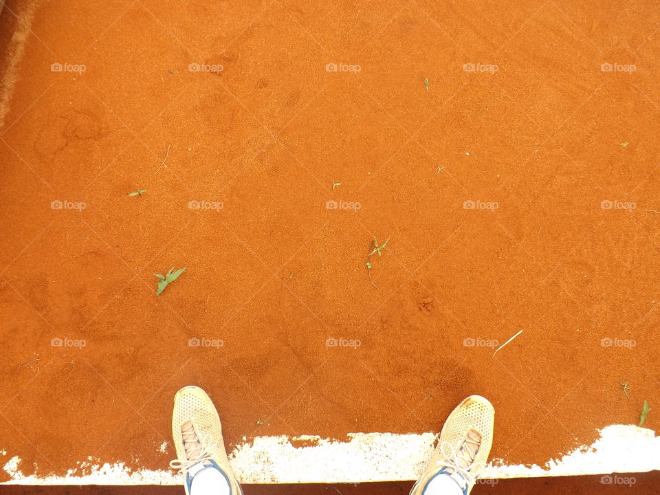 Person standing on clay flooring