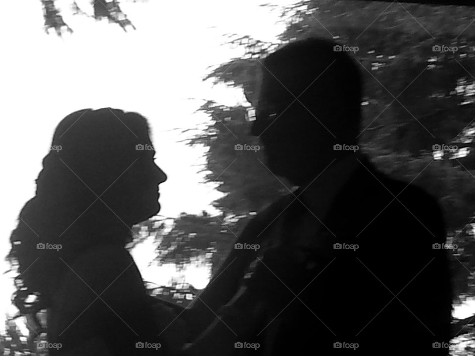 Black and white silhouette of two people dancing