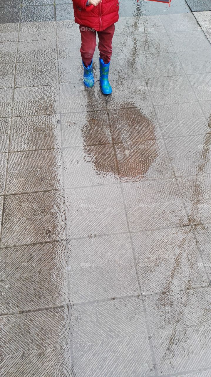 child walking down the rain