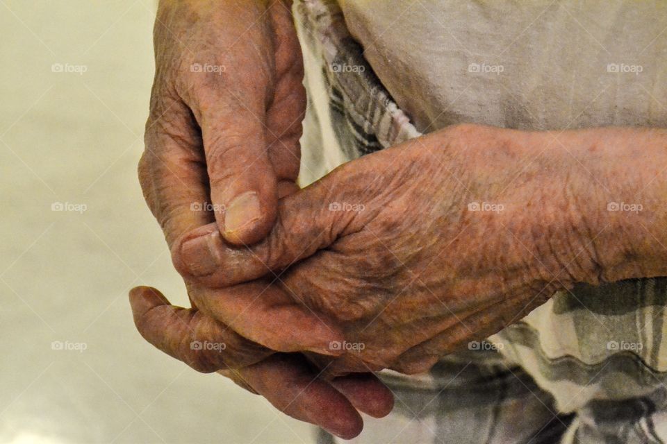 Old womans hands folded