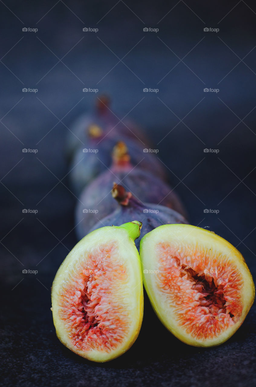 Fresh ripe figs on dark background close up. Top view. Autumn harvest.