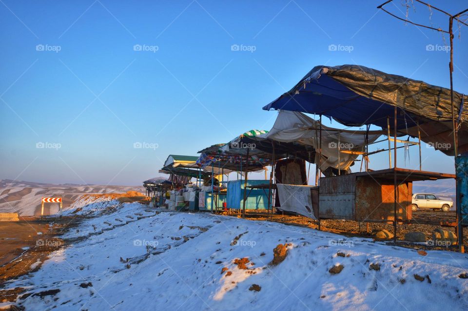 bazaar of the local residents of the Pamirs. trade tents made of fabric and boards against the blue sky