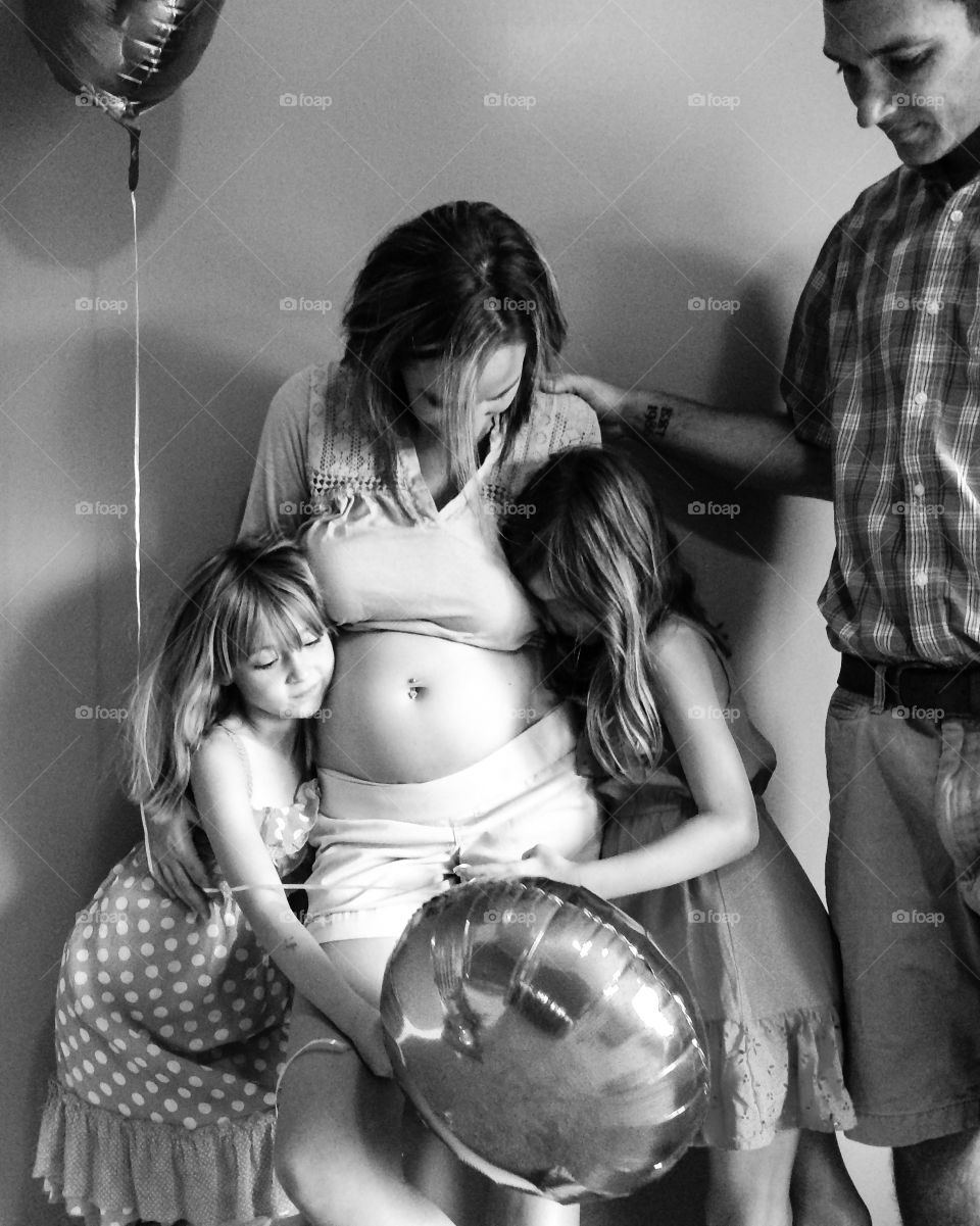 Portrait of family standing against wall