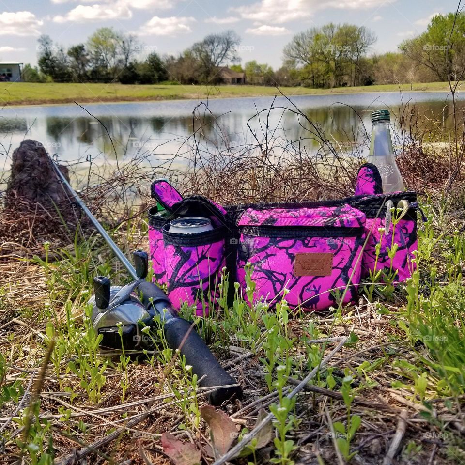 Fishing Gear & Fanny Pack By a Pond