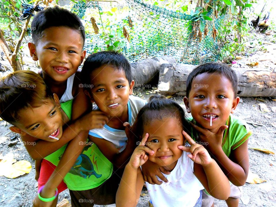 young asian kids smiling at the camera