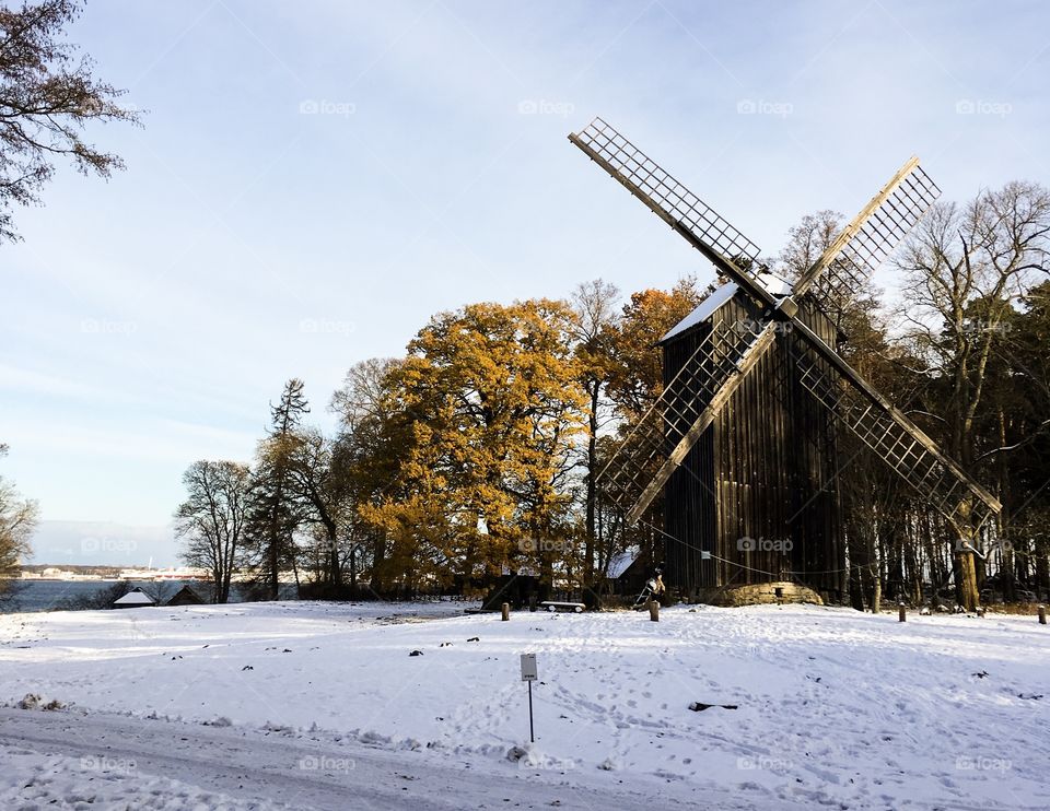 A windmill in a snowy forest park