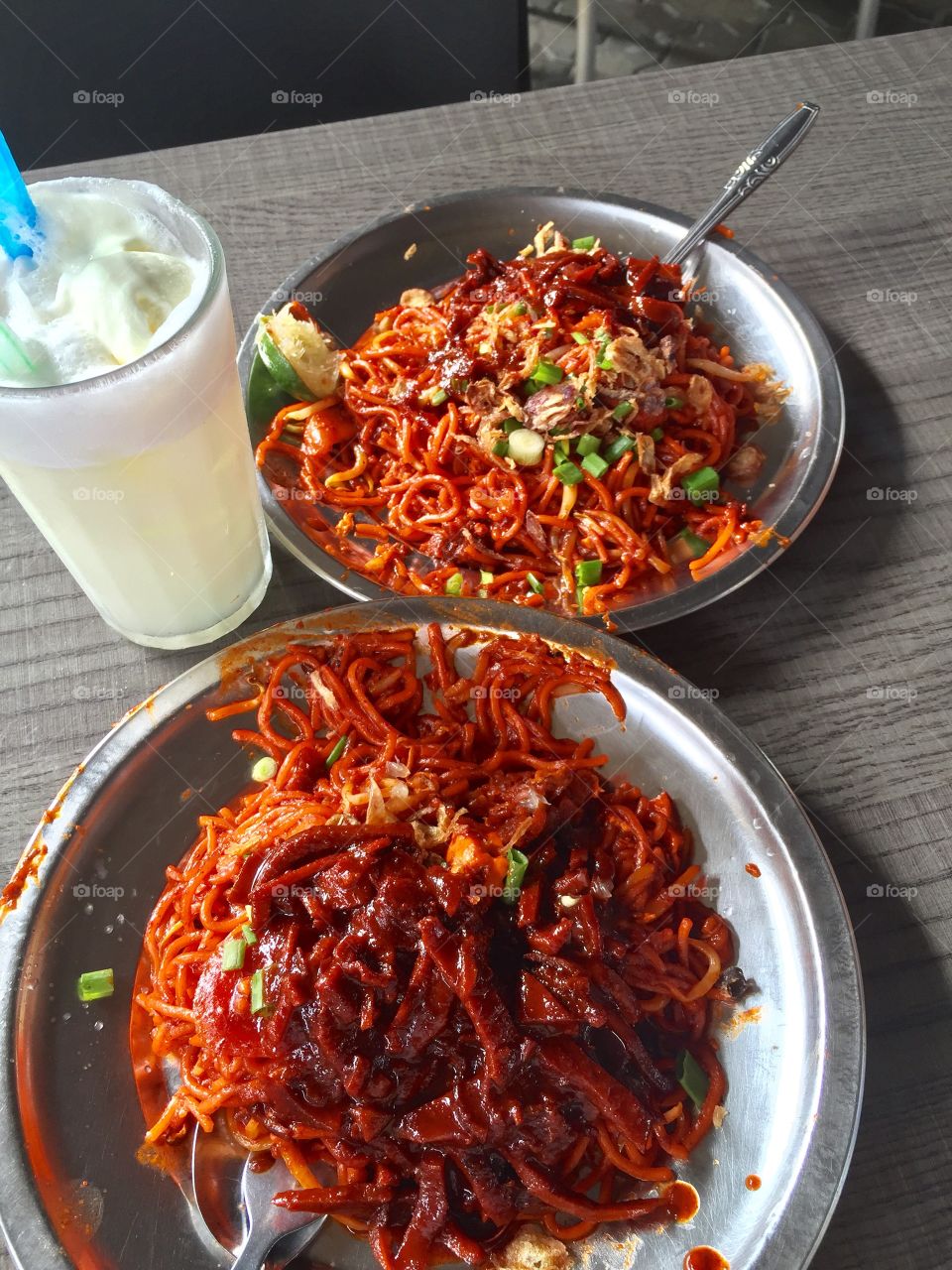 Having spicy fried noodle with coconut juice 