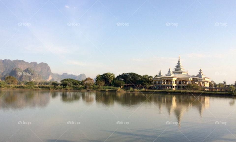 White temple reflecting over water in Hpa An, Myanmar