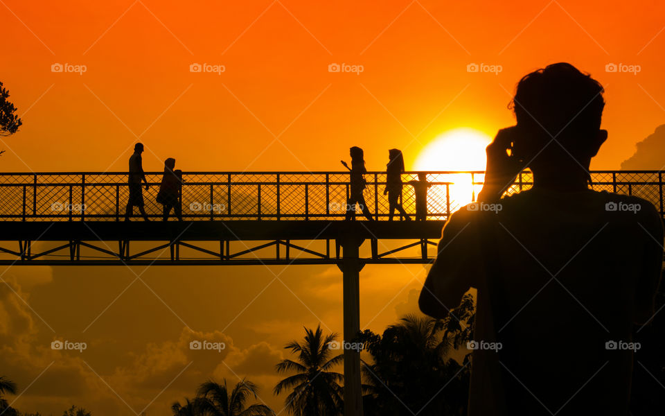 Photographing bridge during sunset