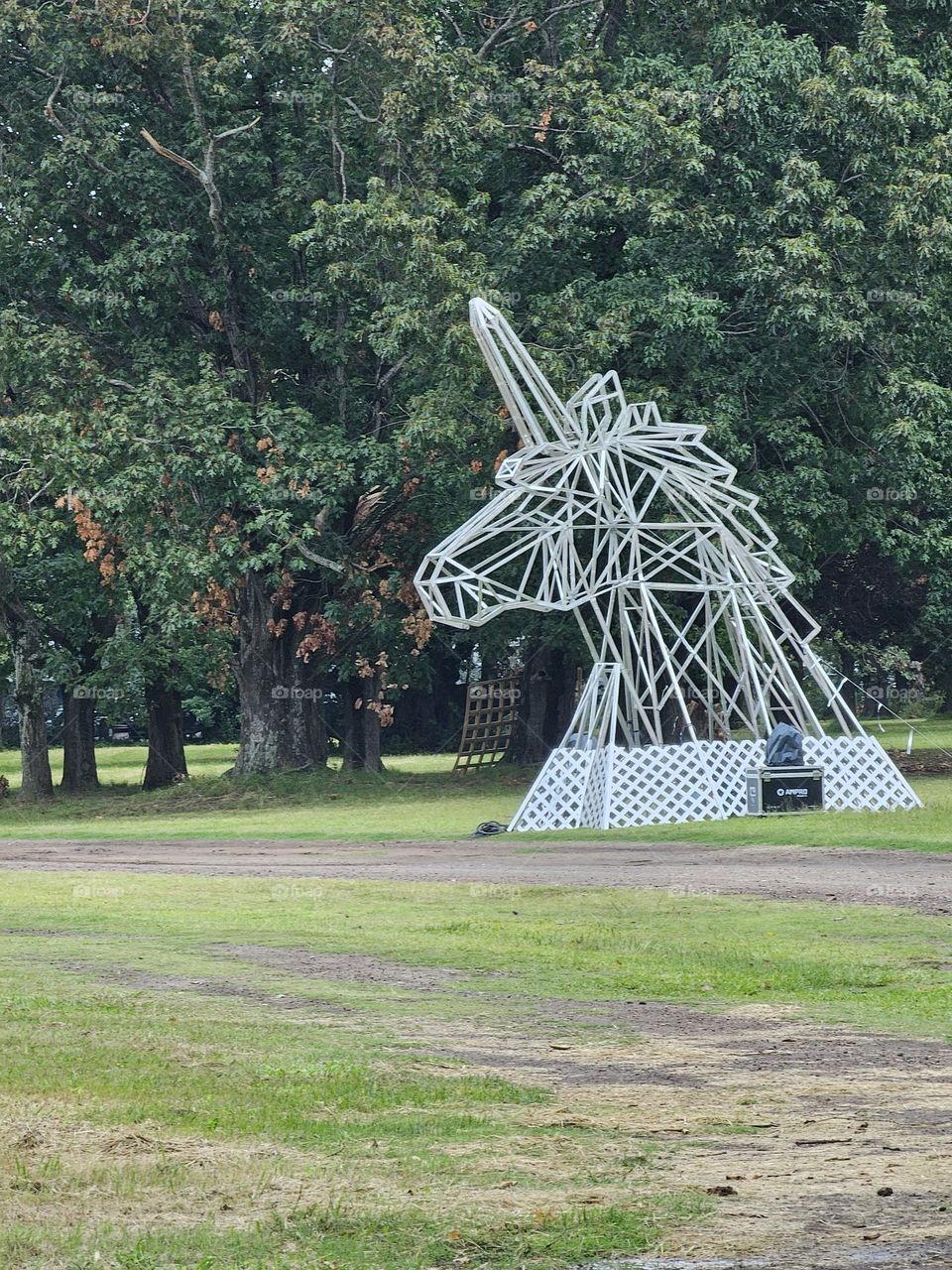 "The Uni horse." A head of a unicorn on a field in the woods after a concert. it really does not belong there.