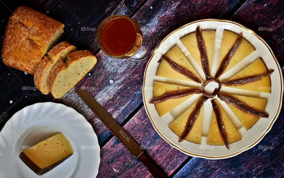 Spanish cured cheese with anchovies, bread and wine.