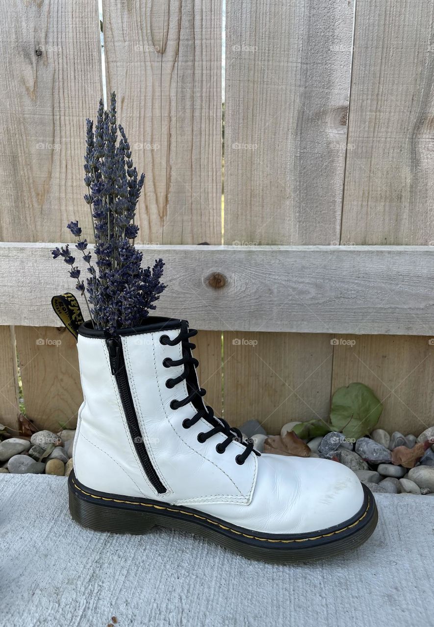 Flower bouquet in a white boot, using a boot as a vase, unusual vases for flowers, flowers in a boot, flowers in White Doc Martens, lavender flowers in a boot vase, creative vases for flowers 