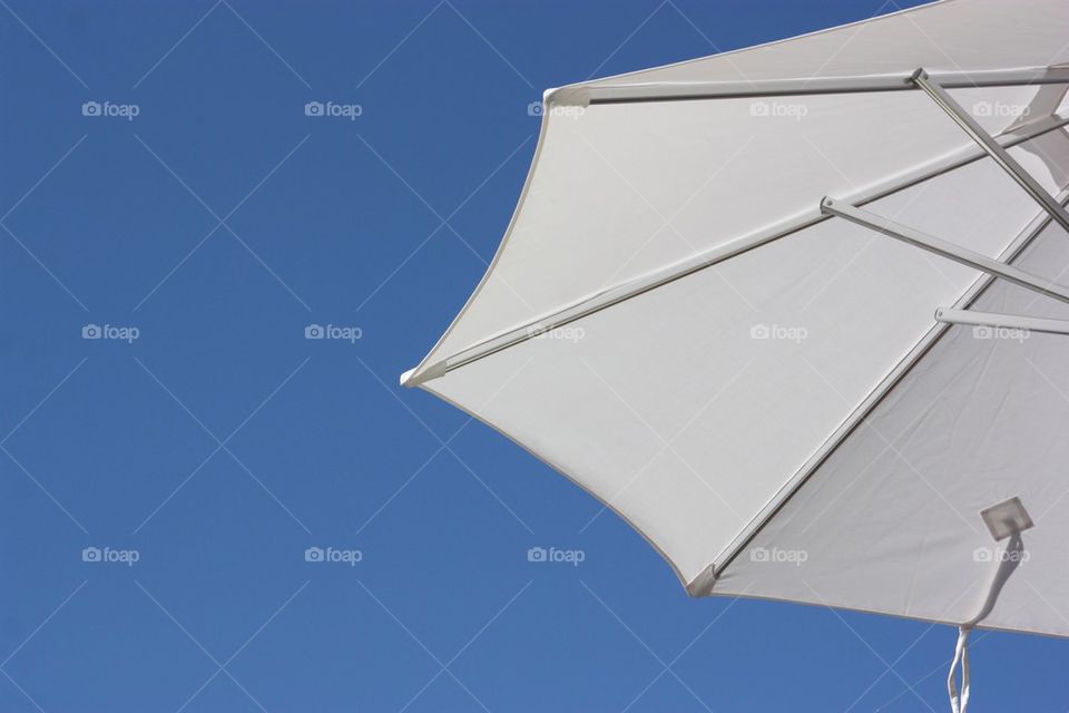 White umbrella blue sky
